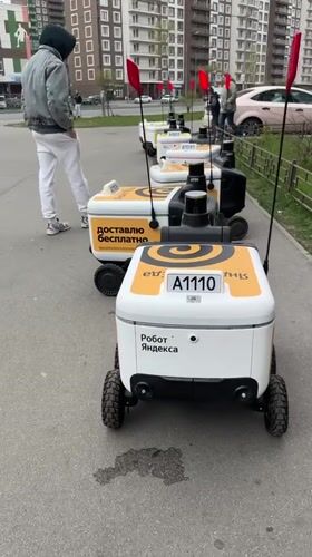 Morning street activity with delivery robots in Murino