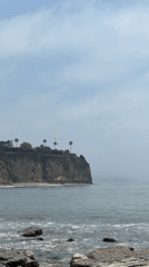 Rock climbers scale Malibu cliff as photographer documents coastal scene