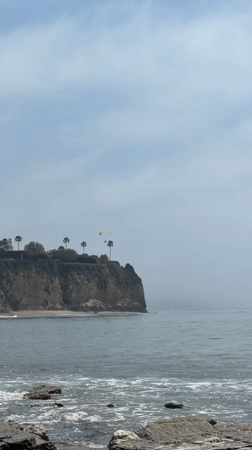 Rock climbers scale Malibu cliff as photographer documents coastal scene