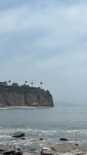 Rock climbers scale Malibu cliff as photographer documents coastal scene