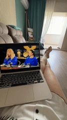 Woman watches laptop shows on couch in Birobidzhan