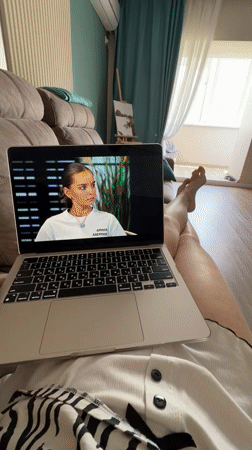 Woman watches laptop shows on couch in Birobidzhan