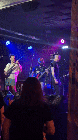 Live band lights up a hazy Badalona stage at night