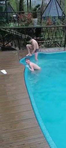 Boys swimming at outdoor pool in Medoveevka, Russia