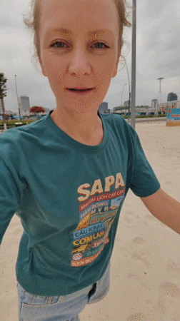 Woman films beach walk in Bai Chay Ward Vietnam