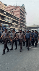 Police officers with protective gear deployed on Dhaka street