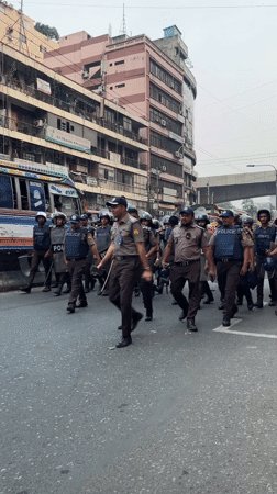 Police officers with protective gear deployed on Dhaka street