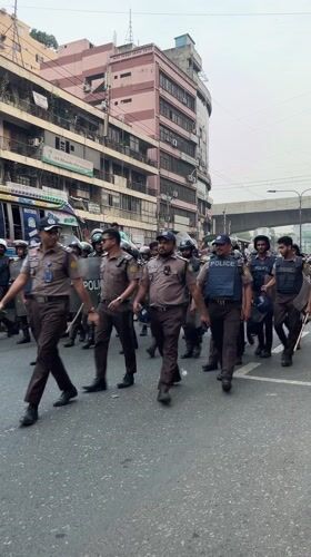 Police officers with protective gear deployed on Dhaka street