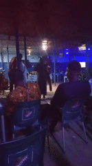 Nighttime bar gathering with live music and drinks captured
