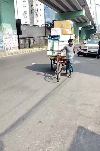 Man in grey t-shirt spotted on sunny Dhaka street