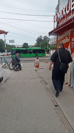 Almaty street life: pigeons, phone shops, bikes, and a construction site