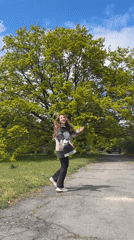 Woman climbs birch tree in Ukrainian park during morning walk