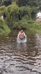 Swimming and splashing in a murky river near Bululawang