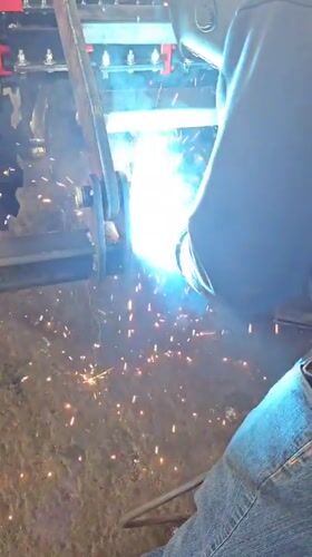 Welder works on industrial machinery in Karnobat, Bulgaria