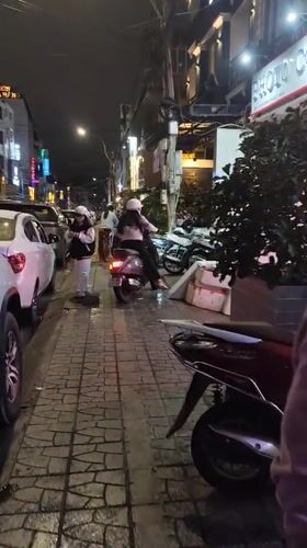 Da Lat street life at night — food, neon, and wet roads