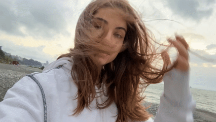 Woman photographed on windy beach in Batumi, Georgia