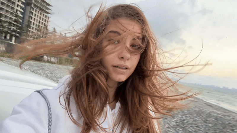 Woman photographed on windy beach in Batumi, Georgia