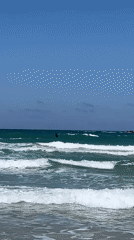 Kitesurfer performs tricks in moderate waves off Acre coast
