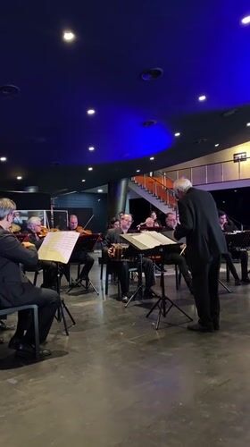 Small orchestra performs for audience in Buenos Aires concert hall