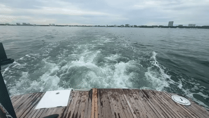 Boat journey captured on video showing wake and cityscape