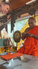 Buddhist monk meets woman in ornate temple, บ้านบางรักษ์