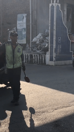 Morning street life and traffic control in Indonesian towns