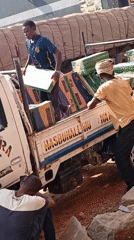 Tilted truck with tile cargo worked by two men in Nigeria