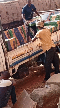 Tilted truck with tile cargo worked by two men in Nigeria