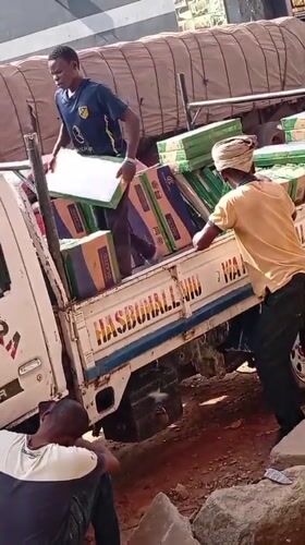 Tilted truck with tile cargo worked by two men in Nigeria