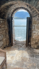 Visitors document historic 9th-century Mediterranean church and surrounding town
