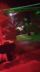 Night dining area captured with colorful lighting, scattered seating