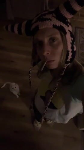 Person in distinctive knit hat smoking indoors in Buenos Aires