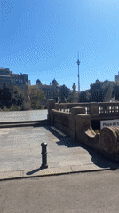 Sunlit Barcelona square with a large central fountain