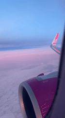 Passenger documents aerial views during commercial flight over coastline