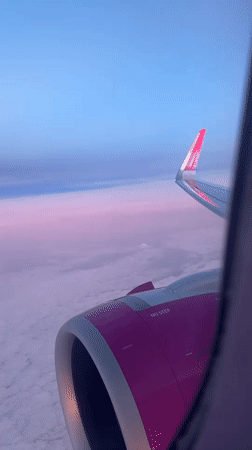 Passenger documents aerial views during commercial flight over coastline