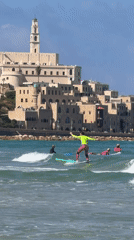 Sunny beach day: surfing, wading, and quiet shoreline moments