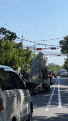 Morning traffic flows through Denpasar streets under clear skies