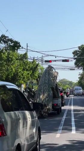 Morning traffic flows through Denpasar streets under clear skies