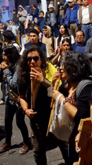 Street gathering features pan flute music, chanting in Arequipa