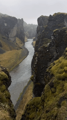 Visitors document Iceland's Fjaðrárgljúfur canyon under misty conditions