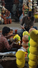 Artisans paint traditional handicrafts at Dhaka street market