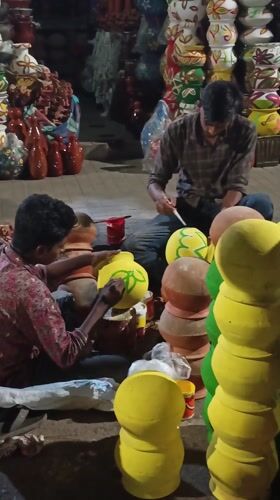 Artisans paint traditional handicrafts at Dhaka street market