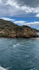 Boat captures scenic Turkish coastal cliffs near Fethiye