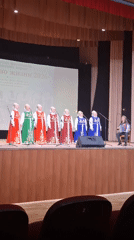 Seven women perform in traditional Russian folk costumes