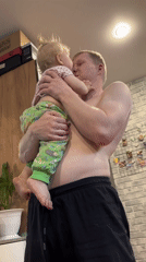 Father and toddler share playful moments at Russian home