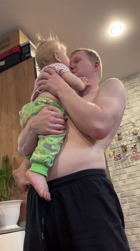 Father and toddler share playful moments at Russian home