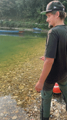 Person throws rocks into Phewa Lake during early morning hours