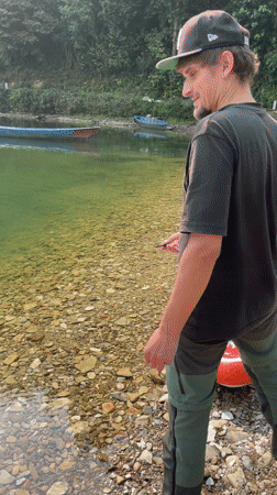 Person throws rocks into Phewa Lake during early morning hours