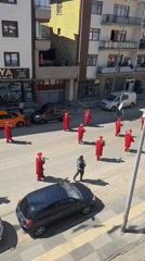 Red-robed procession marches through flag-lined streets in Gölbaşı