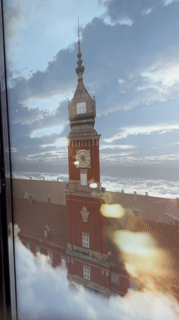 Tourists document Warsaw skyline views from observation deck Sunday evening